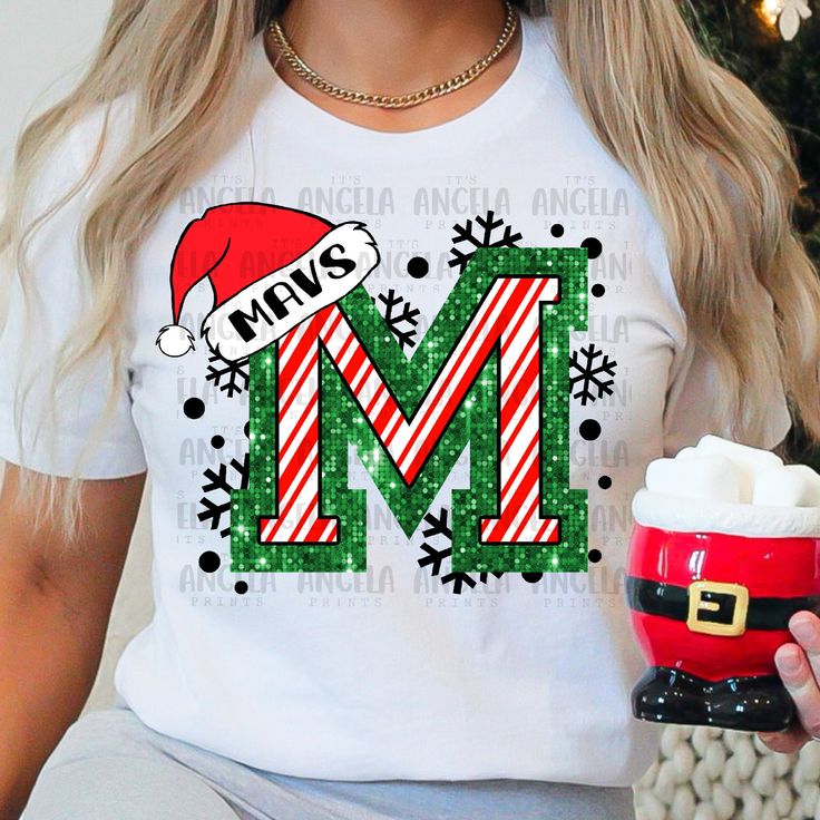 a woman holding a cup with marshmallows and candy canes in it