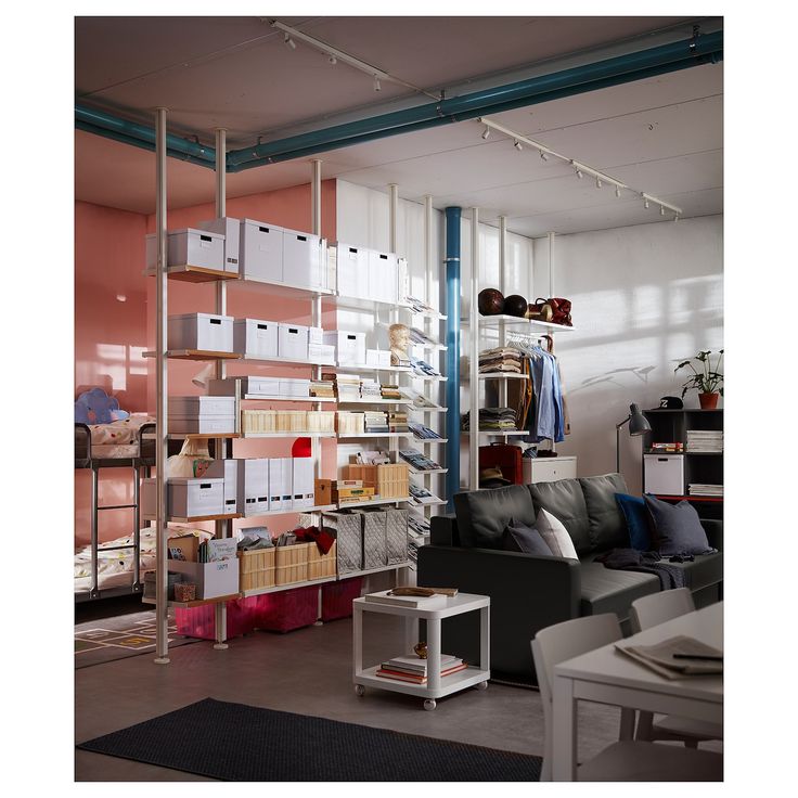 a living room filled with furniture and lots of shelves