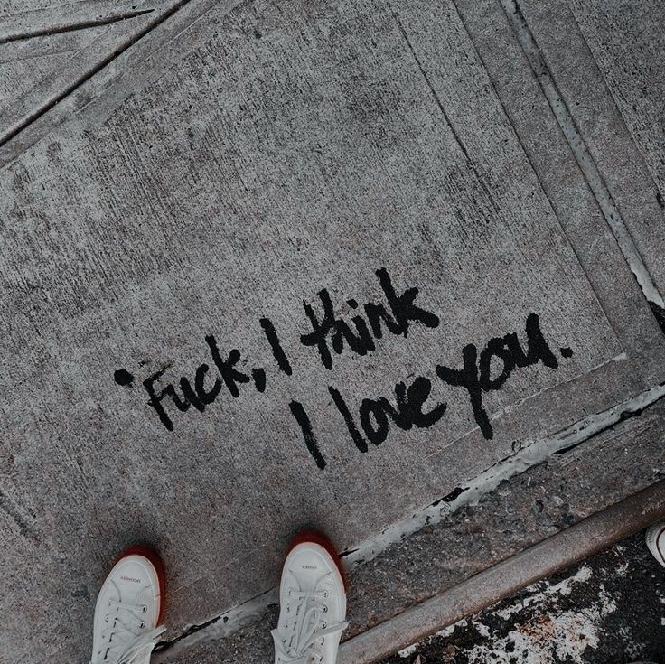 someone is standing on the sidewalk with their feet up in front of them that says, i think i love you