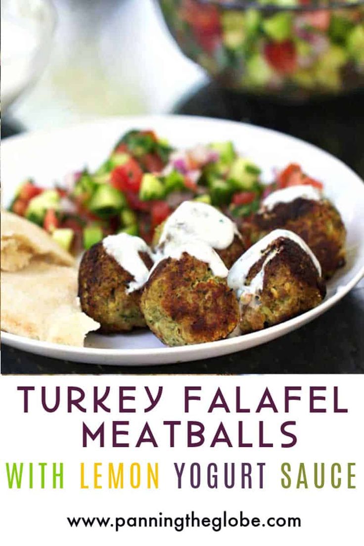 a white plate topped with meatballs next to a salad