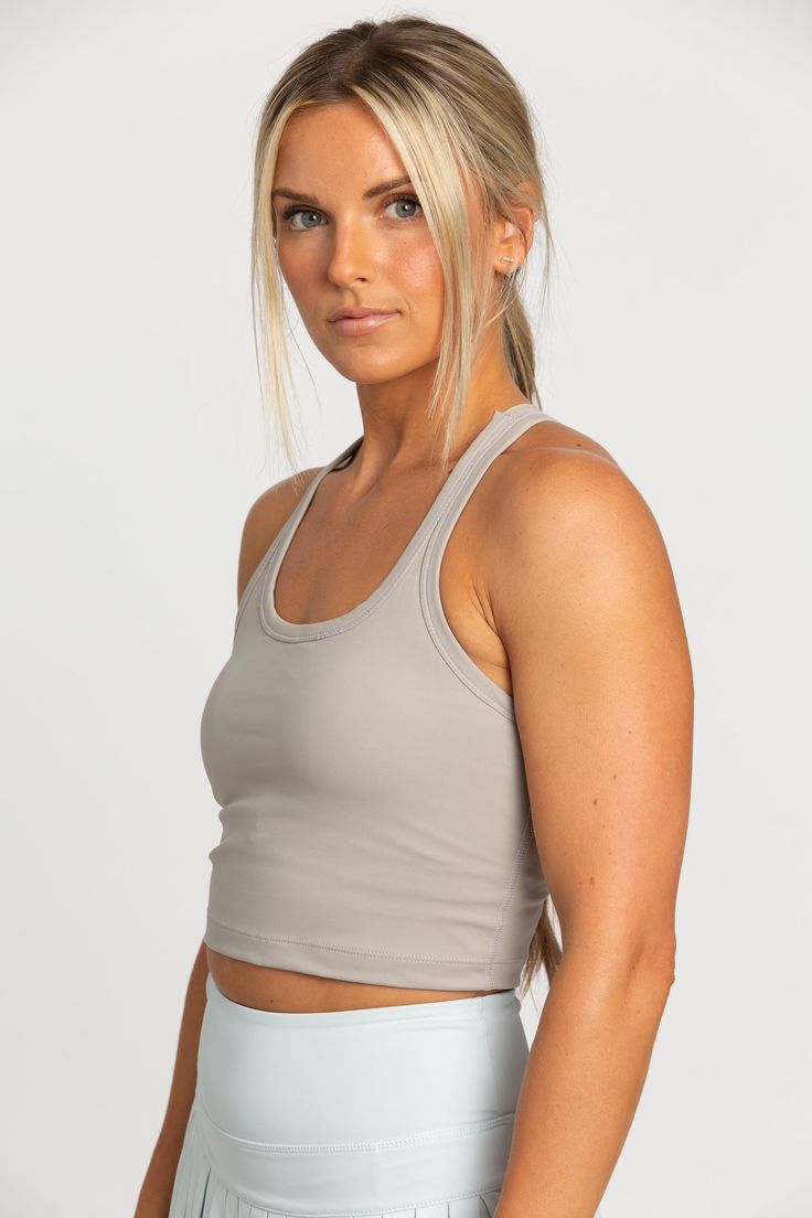 Our Sandstone Racerback Crop Tank features a slight cropped fit and racerback style that is the perfect go-to athletic top. It is complete with sweat-wicking material and a double layer, built-in-removable padded bra. Pleated Tennis Skirt, Tennis Skirts, Athletic Top, Padded Bra, Yoga Tops, Tennis Skirt, Crop Tank, Bra Tops, Model Height