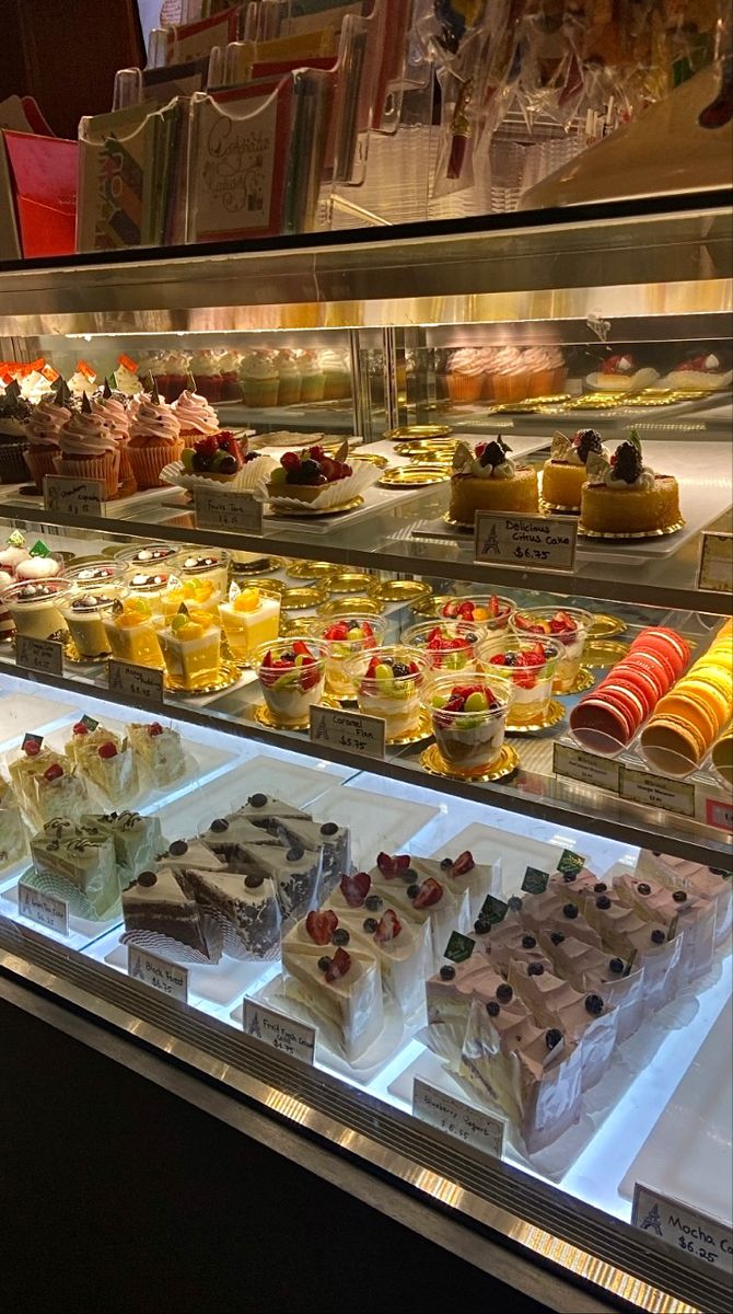 a display case filled with lots of different types of cakes