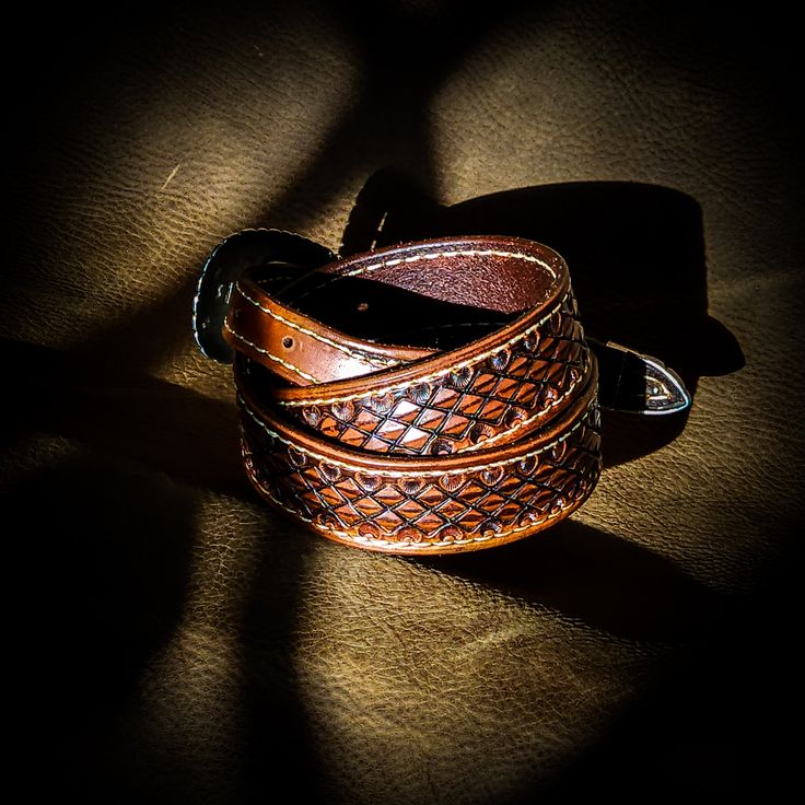 Our custom leather belts are handcrafted with care and precision, using only the highest-quality materials. Each belt is made to order, ensuring a perfect fit and personalized touch. Choose from a wide range of colors and styles to create a belt that's as unique as you are. Invest in a piece that will last for years to come and add a touch of sophistication to any outfit. When you commit to buying one of these custom fit belts, I'll be in contact with you right away to make sure you get a belt t Classic Adjustable Hand Tooled Belt, Classic Adjustable Hand-tooled Belt, Adjustable Artisan Leather Belt Buckles, Western Style Hand Tooled Belt For Formal Wear, Luxury Embroidered Brown Belts, Traditional Leather Belt Buckle, Adjustable, Adjustable Leather Belt Buckles, Traditional Style, Adjustable Leather Belt Buckles In Traditional Style, Adjustable Traditional Leather Belt Buckles