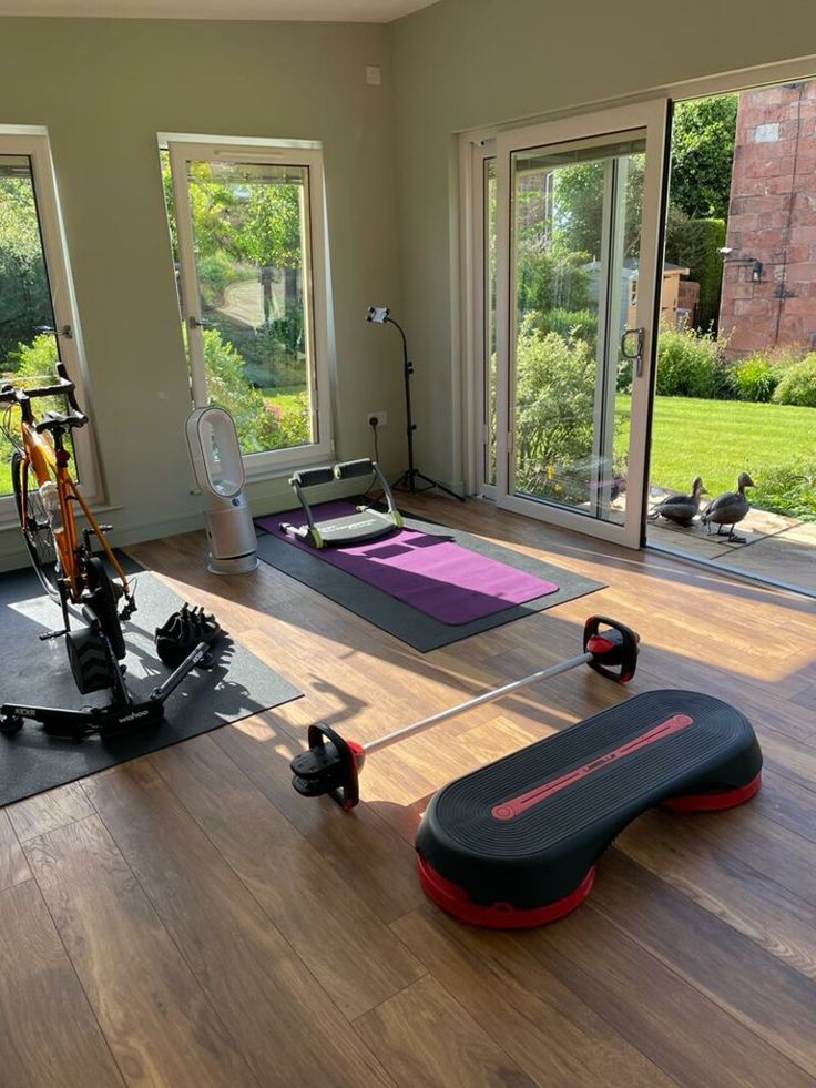 there are many exercise mats in the room and one is on the floor with an exercise bike