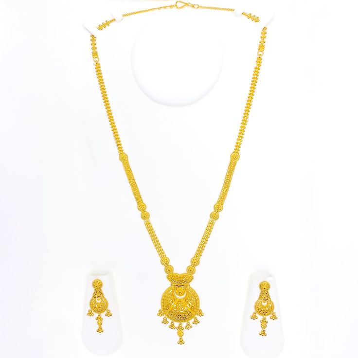 This exquisite 22k gold necklace set, weighing 52.4 grams, features a festive dangling flower design that exudes elegance and charm. The yellow gold finish enhances its luxurious appeal, making it perfect for any special occasion. The necklace has a length of 24 inches with a 2.5-inch drop length and adjustable 1-inch links, secured with a hook lock for convenience. The set includes matching earrings, each measuring 2 inches in length with screw-back posts. Ideal for those who appreciate high-quality craftsmanship and timeless beauty, this dangling flower gold necklace set is a cherished addition to any jewelry collection. PRODUCT DETAILS Gold Purity(karat): 22k Gold Weight(grams): 52.4 Item Finish: Yellow Gold Set Length: 24" Drop Length: 2.5" Adjustable Links: 1" Links Lock Style: Hook L 22k Gold Chain Necklace For Wedding, Festive 22k Yellow Gold Jewelry Sets, 22k Yellow Gold Chain Necklace For Wedding, 22k Gold Necklaces For Celebration With Elegant Design, 22k Gold Necklaces With Elegant Design For Celebration, Elegant Yellow Gold Chain Necklace For Festive Occasions, Elegant 22k Gold Necklaces For Celebration, Elegant Yellow Gold Chain Necklace For Festivals, Traditional Yellow Gold Chain Necklace