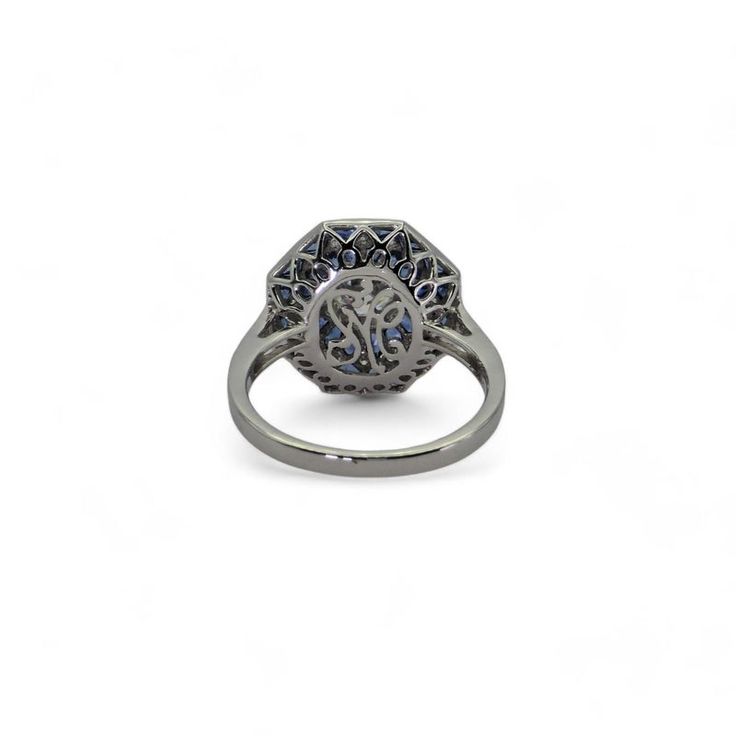 Platinum - Natural Diamond & Blue Sapphire Ring   Metal Type: Platinum (950) Total Item Weight: 5.2 Grams Ring Size: 6.5 (Resizable) 1) Natural Diamond Weight: Center - 0.60 Ct./ Side - 0.153 Ct Diamond Clarity Grade: VVS-VS Diamond Color Grade: F-G Diamond Shape: Center - Old Euro Cut /  Round Shape No. Of Diamonds:  24 2) Stone: Natural Blue Sapphire Stone Weight: 1.25 Ct Stone Shape: Funky Shape Stone Cut: French Cut Stone Color: Blue - Top Quality No. Of Stones: 32 Gia Certified Sapphire Octagon Ring, Luxury Octagon Sapphire Ring With Center Stone, Brilliant Cut Sapphire Ring In Octagon Shape, Brilliant Cut Sapphire Ring Octagon Shaped, Sapphire Rings With Octagon Brilliant Cut, White Gold Sapphire Ring With Brilliant Octagon Cut, White Gold Octagon Sapphire Ring With Brilliant Cut, Brilliant Cut Octagon Sapphire Ring, Timeless Hallmarked Sapphire Ring