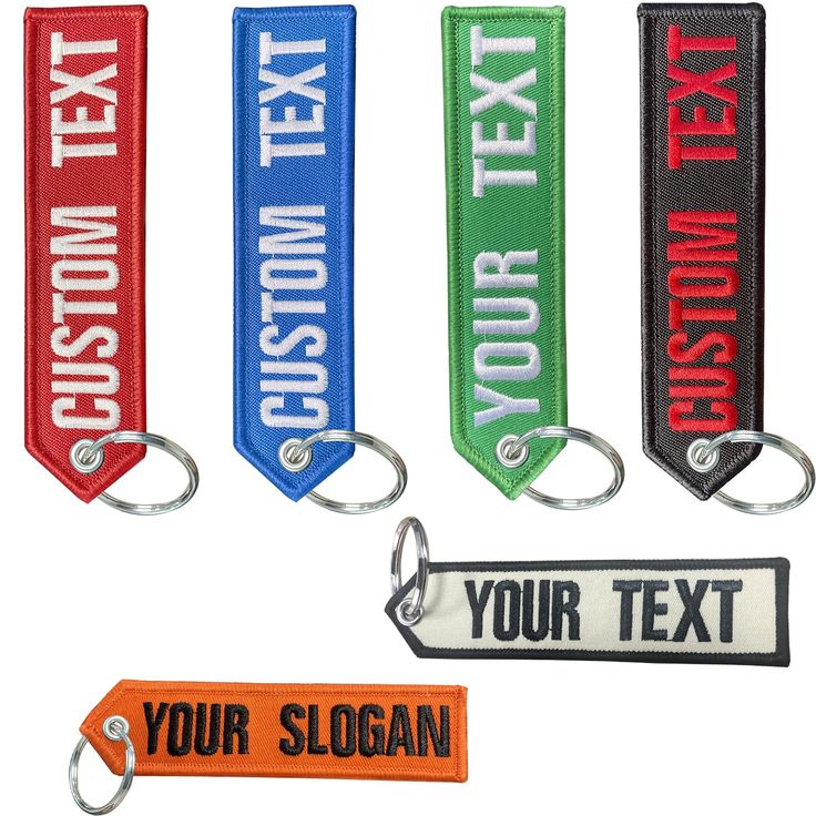 four keychains with different colors and text on them