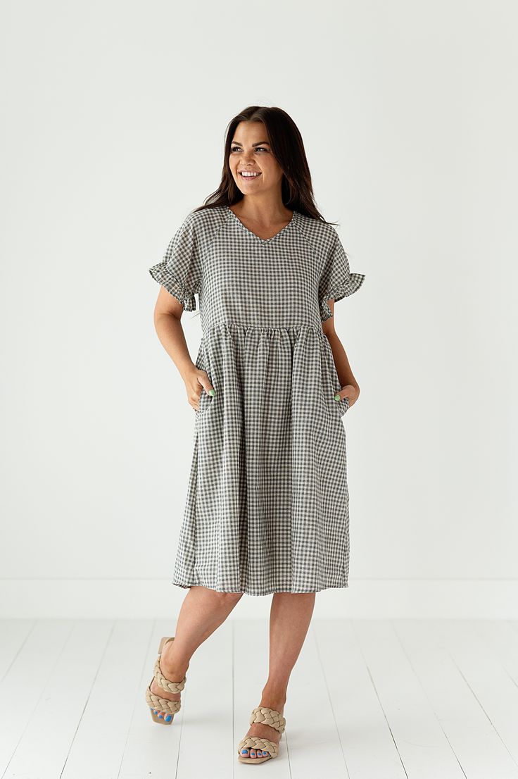 Features V-Neck Baby doll midi dress Flutter sleeve Pockets 100%Polyester Size + Fit Small 0-4, Medium 4-8, Large 8-12, X-Large 12-16 Model is 5'4", a size 3 and is wearing a Small Runs true to size Bust measurements are taken while laying flat and doubled and do not account for stretch. Size Bust Length Small 34" 41" Medium 36.5" 41" Large 39" 41.5" X-Large 41" 41.5" Casual Flutter Sleeve Midi Dress For Spring, Casual Flutter Sleeve Midi Dress For Brunch, Casual Midi Dress With Flutter Sleeves For Brunch, Casual Midi Dress With Flutter Sleeves And Ruffles, Casual Midi Dress With Flutter Sleeve And Ruffle Hem, Relaxed Fit V-neck Dress With Ruffles, Casual Midi Dress With Ruffle Sleeve For Spring, Spring Plaid Midi Dress Knee-length, Daywear Midi Dress With Ruffle Hem And Sleeves