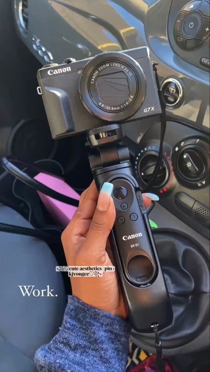 a person holding a camera in their left hand and recording the inside of a car