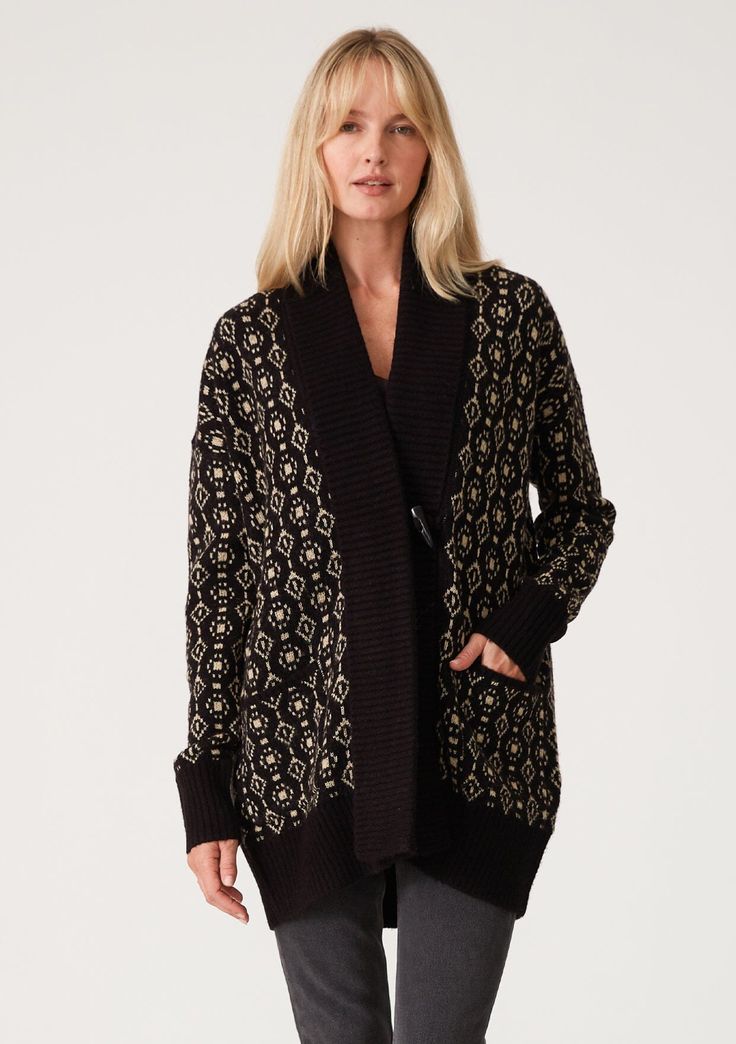 [Color: Black/Taupe] A front facing image of a blonde model wearing a cozy bohemian cardigan in a black and taupe geo jacquard design. With contrast ribbed trim Black Fair Isle Cardigan For Fall, Black Fair Isle Pattern Cardigan For Fall, Fall Jacquard Knit Cardigan For Layering, Elegant Jacquard Knit Cardigan For Winter, Cozy Jacquard Knit Outerwear For Cold Weather, Cozy Jacquard Knit Cardigan For Fall, Black Outerwear With Fair Isle Pattern For Fall, Black Long Sleeve Cardigan With Fair Isle Pattern, Black Jacquard Knit Long Sleeve Outerwear