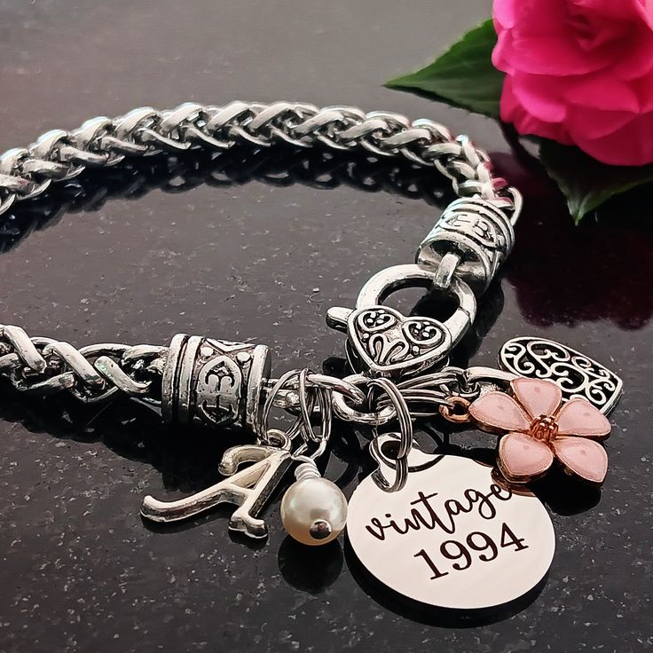 Celebrate her milestone birthday with this sentimental '30th birthday' keepsake. The bracelet features a 'vintage 1994' stainless steel charm, flower, filigree heart, cream pearl, and an initial for personalization. Thirtieth birthday gift for Wife, Spouse, Girlfriend, Cousin, Best Friend, Mother, Daughter, Sister, Aunt, Niece, Family member, Friend, Boss, or Coworker. Gift from Spouse, Husband, Mother, Father, Grandmother, Grandfather, Uncle, Sister, Brother, Aunt, Niece, Coworker, Family, or Friend.  Finishes: Silver Materials: *7.87 inch wheat bracelet *'vintage 1994' stainless steel *filigree heart, pink enamel flower, script initial, zinc alloy *cream pearl, 6mm Gift Packaging: The bracelet will arrive in an organza drawstring bag inside a white box with a gold stretch ribbon on a car Personalized Vintage Jewelry For Birthday, Jubilee Charm Bracelet For Anniversary On Mother's Day, Vintage Personalized Jewelry For Birthday, Mother's Day Anniversary Charm Bracelet, Mother's Day Anniversary Charm Bracelet With Birthstone, Mother's Day Birthstone Charm Bracelet For Anniversary, Mother's Day Anniversary Birthstone Charm Bracelet, Valentine's Day Anniversary Jubilee Charm Bracelet, Mother's Day Birthstone Charm Bracelet For Birthday