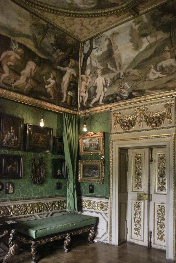 an ornate room with paintings on the ceiling and green drapes hanging from the ceiling