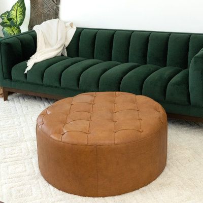 This cocktail ottoman completes your glam living room with a sleek, modern look. It's crafted from solid wood in a circular shape padded with foam for padding and support. The design features genuine leather upholstery in a warm tan hue decked out with diamond button tufting. We love that ottomans are so versatile - you can use them to kick up your feet, as extra seating, or even add a decorative tray and create a makeshift coffee table. | Willa Arlo™ Interiors Paulsen 37.4" Wide Tufted Round St Circular Ottoman, Round Leather Ottoman, Leather Storage Ottoman, Dream Sofas, Glam Living Room, Modern Ottoman, Tufted Leather, Leather Pouf, Round Ottoman