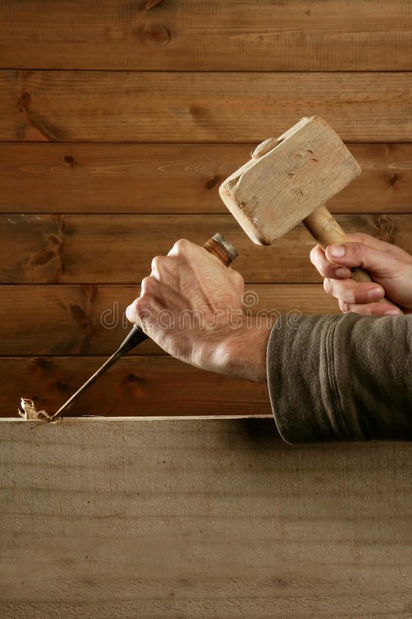 a man is holding a hammer and nailing the wood planks with his hands royalty images