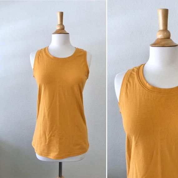 Basic cotton knit tank top.  This is a nice basic tank top that can be worn alone or layered. Length from shoulder to hem is about 25”  *Length can be adjusted for you as neededColor shown is Mustard Garments are Made To Order Please allow 7-10 days for your item to be sewnBelow are my standard size measurements, which are simply a guideline, if you would like to include your personal measurements in the notes to seller box during checkout, I will be sure to make you the best fit ~ if you have a Cheap Mustard Sleeveless Top, Cheap Yellow Sleeveless Tank Top, Cheap Yellow Sleeveless Blouse Tank Top, Basic Cotton Tank Top For Spring, Spring Basic Cotton Tank Top, Basic Fitted Everyday Tank Top, Basic Stretch Vest Top, Basic Everyday Fitted Tank Top, Basic Fitted Tank Top For Everyday