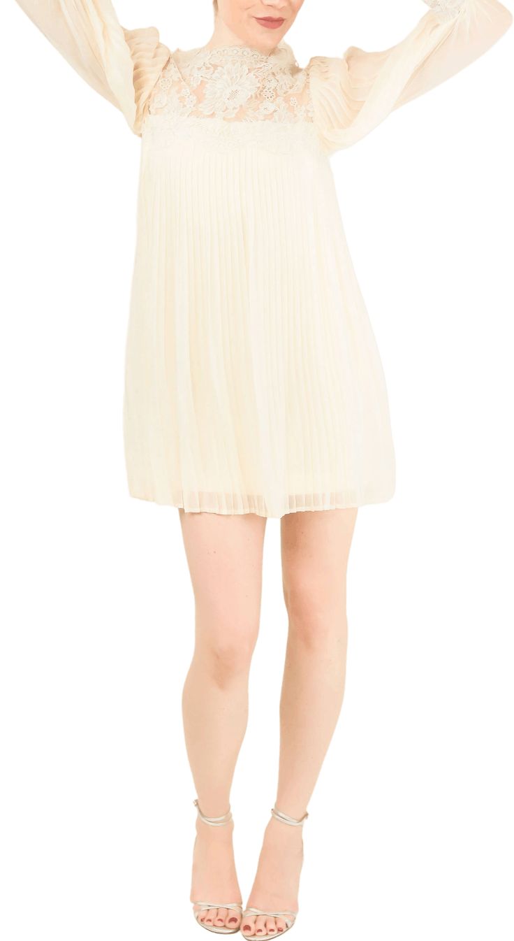 Whether you're walking down the aisle or just love a flowing ivory piece, this mini dress can we worn a million ways. An excellent option for bridal celebrations and honeymooning. Perfect as is with a pair of ivory heels, or wear it again and again paired on top of a pair of jeans.The mini dress fastens with buttons and a hidden zipper down the back. It is in great vintage condition. It has some minor spots at the underarms and in the pleated silk due to age/wear. It is not noticeable at all when worn. Please see measurements to confirm sizing. MeasurementsShoulder: 17"Bust: 34"Length: 30" (down the center) Luxury Cream Lace Mini Dress, Vintage Beige Mini Dress With Lace Trim, Cream V-neck Feminine Mini Dress, Luxury A-line Mini Dress With Lace Trim, Cream V-neck Mini Dress With Lace Trim, Ivory Heels, Mini Dress Shop, Walking Down The Aisle, Lace Mini Dress