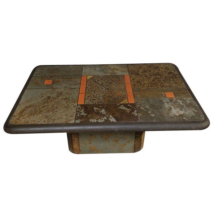 a table that has some kind of patchwork design on the top and bottom, with orange strips at the edge