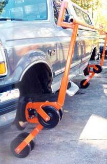 an orange tow dolly attached to the back of a truck