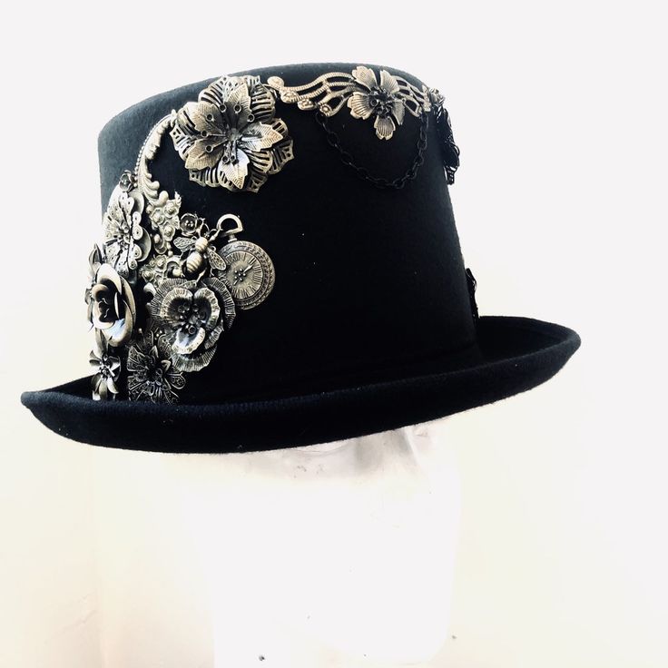 Sometimes that touch of eccentricity is just what you need to set yourself apart from the crowd and nothing will let you do so better than a great head topper, one like this Neo-Victorian top hat. Combining a vintage Victorian style with the mechanical aesthetic of steampunk, this unisex top hat is fitted with a variety of Victorian vintage baubles and fantastical cogs & gear ornaments on a formed Felt hat with with Ribbon Band. Choosing the custom theme Hat option? Whether you are a high-so Mechanical Aesthetic, Vintage Baubles, Victorian Top, Women Steampunk, Black Steampunk, Hat Inspiration, Steampunk Top, Steampunk Top Hat, Metal Mask