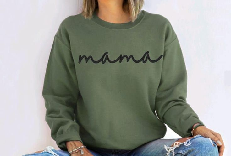 ** PLEASE NOTE ** Orders received AFTER Sunday, 12/8 may not arrive in time for Christmas.  Mama Sweatshirt-Mama Embroidered Sweatshirt-Custom Embroidered Sweatshirt-Mother's Day Gift-Crewneck Sweatshirt-Gift for Mom-Mom Sweatshirt Custom Embroidered Mama Sweatshirt makes for a great gift for Mom.  This custom sweatshirt also makes for the perfect Mother's Day Gift. This crewneck sweatshirt is super soft, unisex in size and makes for a spectacular gift for any Mama. Color Combinations Shown in P Casual Embroidered T-shirt For Mother's Day, Mother's Day Casual Long Sleeve Sweatshirt, Casual Long Sleeve Sweatshirt For Mother's Day, Casual Crew Neck Sweatshirt For Mother's Day, Green Long Sleeve Tops For Mother's Day, Black Names, Green Sweatshirt, Great Gifts For Mom, Mama Sweatshirt