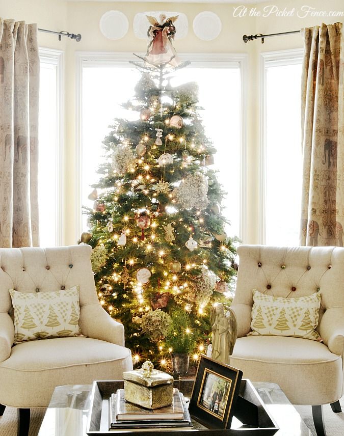 a living room with a christmas tree in the corner