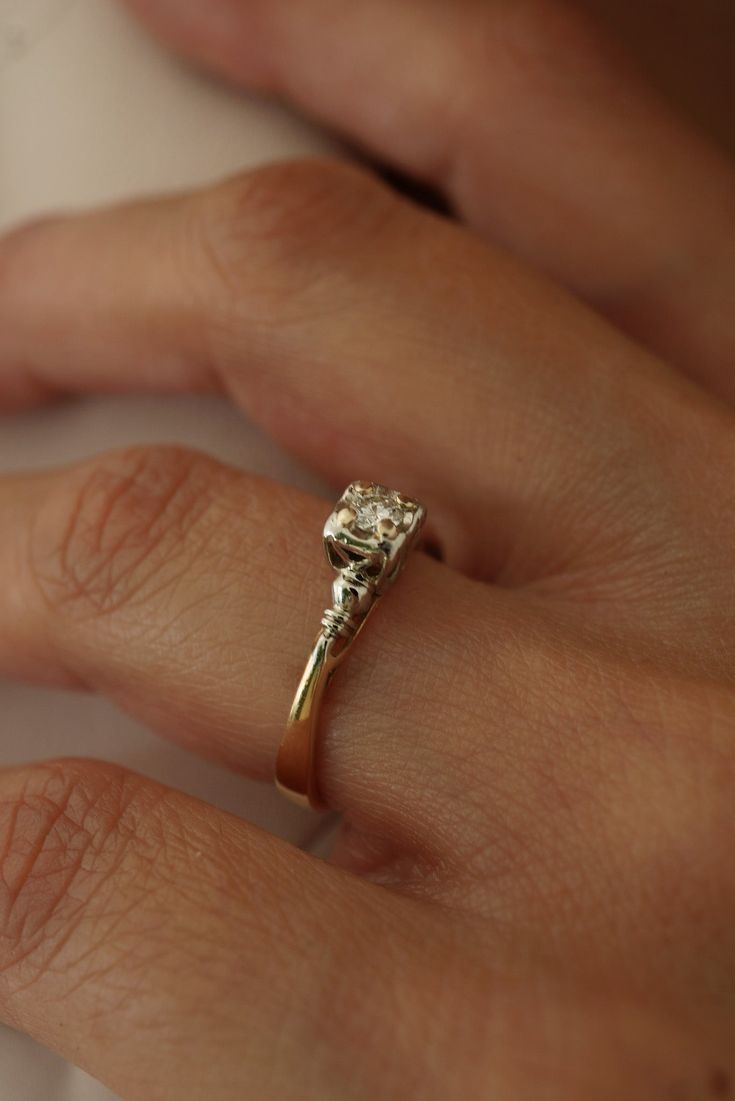 a woman's hand with a diamond ring on it