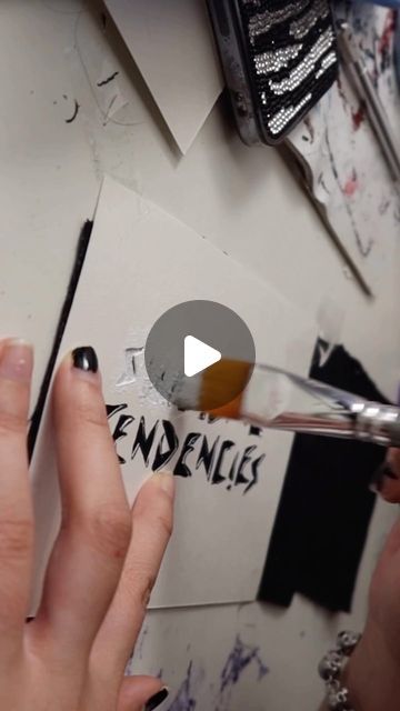 someone using scissors to cut out the word endengles on a piece of paper