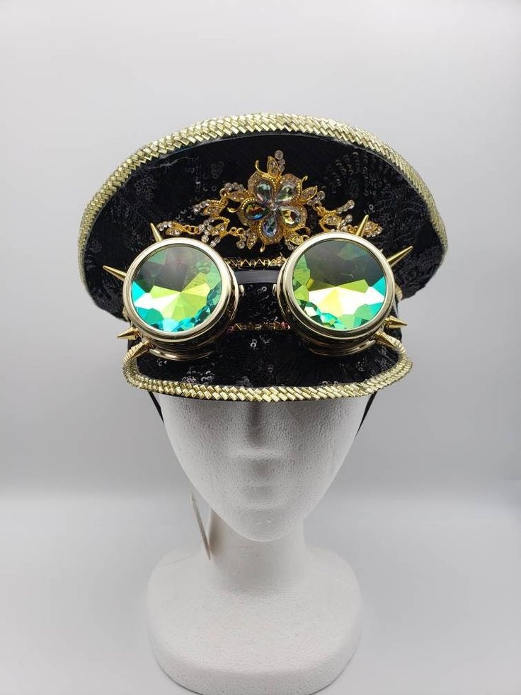 Black sequin police-style hat with gold trim and gold spiked goggles. Elastic strap fits snugly under the chin. One size. SHOP POLICIES: Orders placed Monday-Friday generally ship next day. Orders placed Saturday/Sunday ship the following Tuesday. Cancellations are permitted before an item ships. Please note that we do not accept returns. Luxury Gold Festival Hat, Novelty Adjustable High Crown Costume Hat, Novelty Costume Hat With Adjustable High Crown, Gold Steampunk Costume Accessories For Costume Party, Gold Steampunk Costume Accessories For Parties, Adjustable Hat For Carnival, Gold Steampunk Costume Accessories For Festival, Vintage Adjustable Costume Accessories For Festivals, Gold Costume Hats With Round Crown