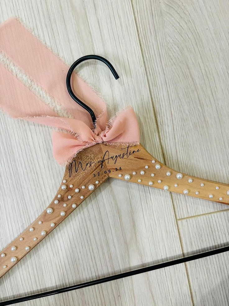 Our pearl hangers are elegant and stylish- made for displaying your wedding attire in style. Hangers are handcrafted to ensure that each piece is unique in its own way! Our hangers are laser engraved. Leaving the personalized name a dark brown color. With adhesive pearls added to create the elegant appearance. Pearls are completely optional to you! Our hangers are just as eye catching without the touch of pearls! We offer a few styles of elegant fonts for you to choose from, please view the last Pearl Hangers, Bridal Gown Hanger, Pearl Hanger, Bridesmaid Hanger, Hanger Wedding, Wedding Titles, Bridesmaid Hangers, Wedding Dress Hanger, Dress Hanger