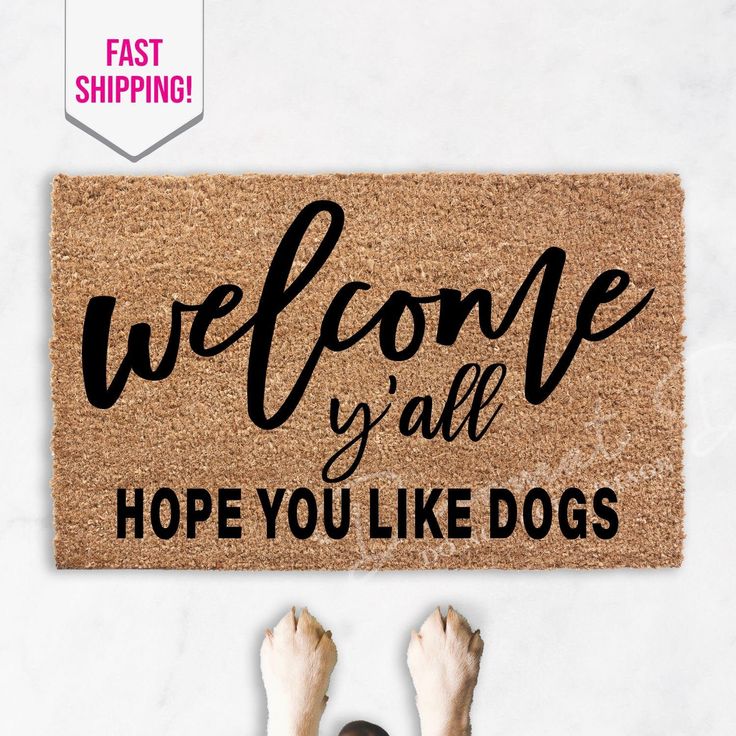 a person standing in front of a door mat with the words welcome yah hope you like dogs on it