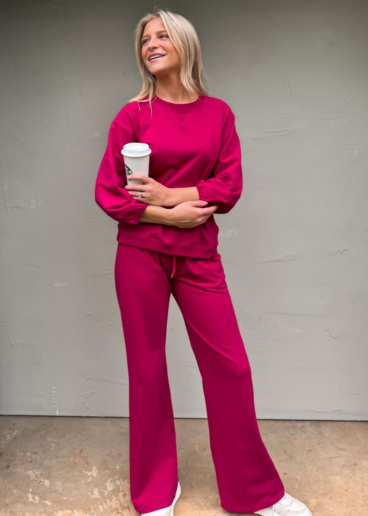 Our Another Love Quincy Wide Leg Pants are the perfect comfy fit for running errands or chillin' at home. These cozy trousers are designed with an elastic drawstring waist for a go-to casual look. And they pair perfectly with our Bryce Raglan Sleeve Sweatshirt for a matching ensemble. Get your loungewear on! True to size Olivia is wearing xsmall Wide leg Elastic drawstring waist Fabric has some stretch Color: Ruby Pink Fabric: 95% COTTON 5% SPANDEX Casual Wide Leg Activewear For Relaxation, Trendy Solid Color Joggers For Loungewear, Athleisure Pants With Elastic Waistband For Loungewear, Spring Sweatpants With Elastic Cuffs For Lounging, Trendy Relaxed Fit Activewear For Lounging, Trendy Leisure Pants With Elastic Cuffs, Casual Lounging Pants With Elastic Cuffs, Comfy Relaxed Fit Pants With Elastic Cuffs, Pink Drawstring Sweatpants For Leisure