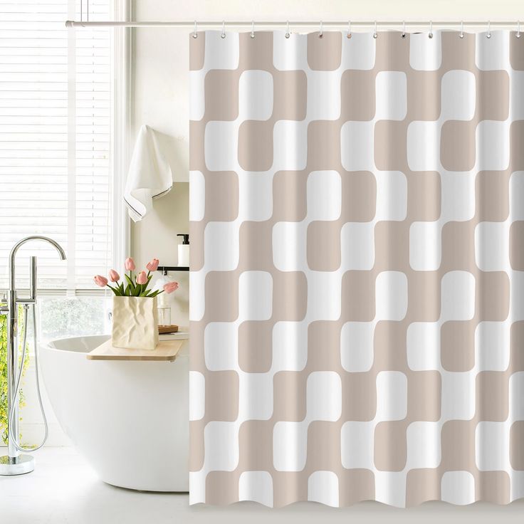 a white tub sitting next to a shower curtain