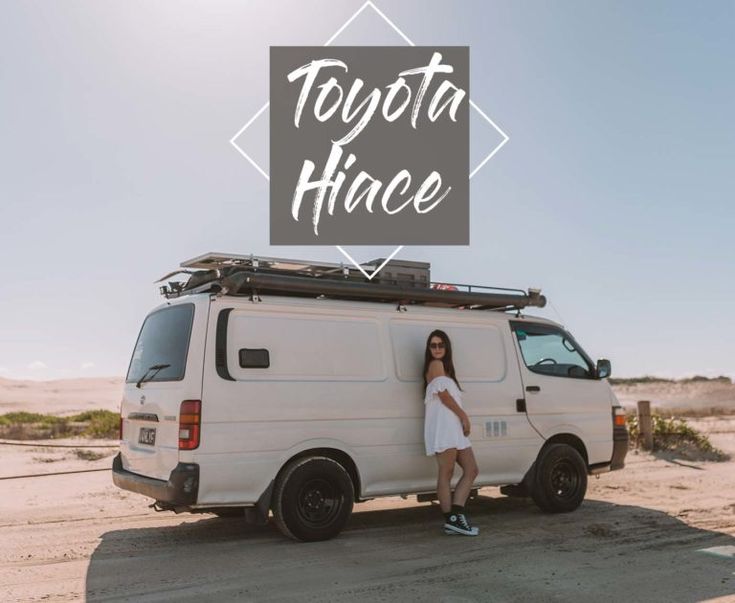 a woman standing in front of a van with the words toyota hiace on it