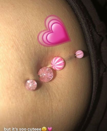 the belly is decorated with pink and white candies as well as heart shaped buttons