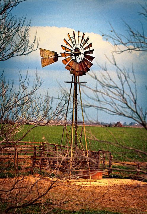 an old windmill in the middle of a field