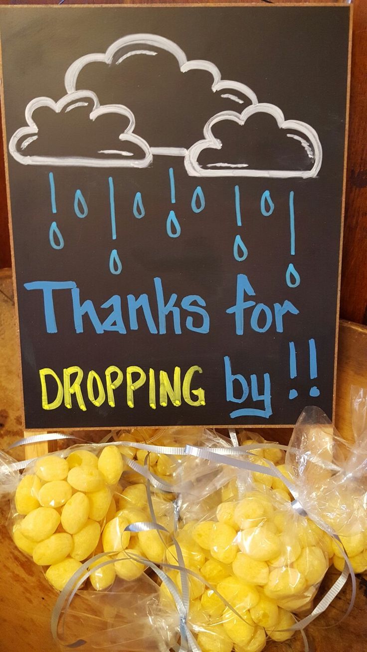 there is a sign that says thanks for dropping by and bags of corn on the table