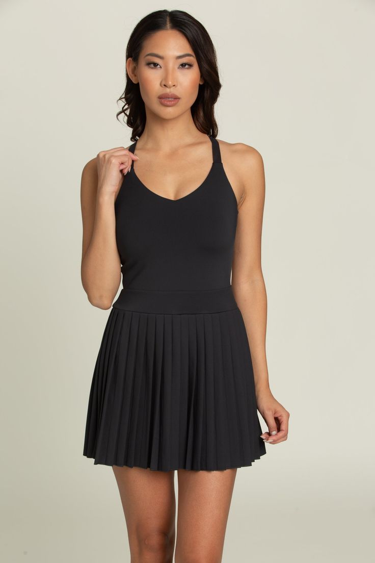 Introducing our Black Y Back Adjustable Pleated Dress that is sure to become a staple in your wardrobe. If you love the look of our Pleated Skirts but prefer an easier "all-in-one" option, then this will be the perfect match for you. Complete with built-in shorts, pockets, and adjustable straps for just the right amount of support, it's a versatile must-have. Tennis Skirts, Pleated Skirts, Spandex Shorts, Athletic Top, Yoga Tops, Design Model, If You Love, Xl Dress, Pleated Dress