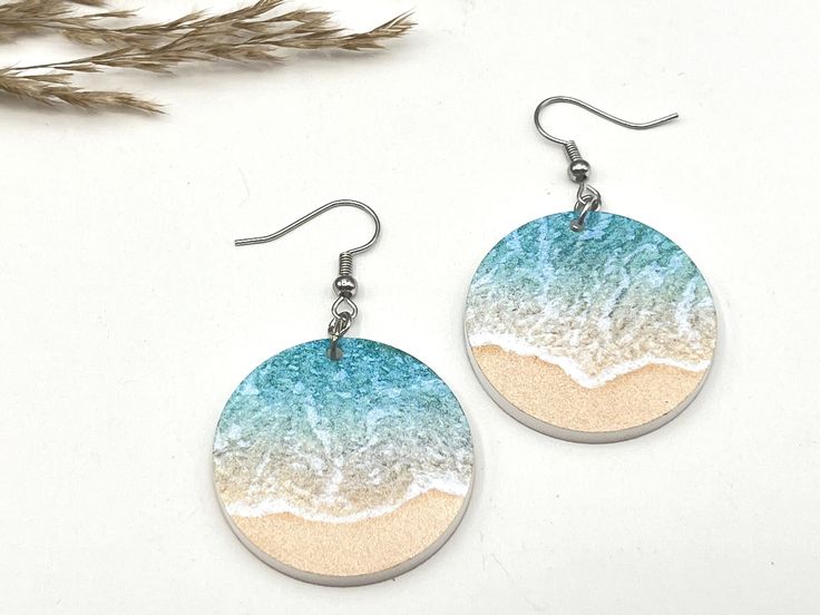 "Beach Themed Earrings These beautiful clear acrylic beach-inspired earrings are perfect for summer. Grab a pair or two for that beach or cruise vacation. Excellent gift idea!  * These earrings are made of printed Acrylic. Acrylic gives that minimalist feel, is lightweight, and comes with a bright vibrant print.  * The beachy design is printed on both sides * The earrings are 2 long, 1\" wide, and 1/8\" thick  * Hardware comes in either silver or gold plated. * Includes fishhook with rubber earring stoppers * All of our items are handcrafted in Topsail Nc We offer free shipping on all orders over $35! Follow our shop to get notifications of new designs and Sales!!  Looking for customized earrings for a special occasion or holiday, feel free to contact us.A" Summer Vacation Drop Earrings, Hypoallergenic Blue Earrings For Summer, Summer Beach Dangle Earrings, Handmade Beachy Earrings For Summer, Handmade Earrings For Beach Season Gifts, White Resin Earrings For The Beach, Summer Beach Drop Earrings, Nickel-free Drop Earrings For Vacation, Hypoallergenic Summer Vacation Jewelry