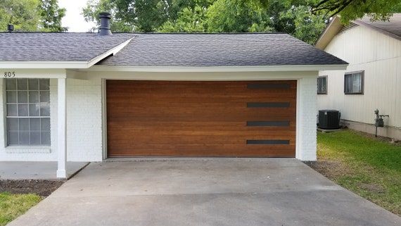 a white house with a brown garage door