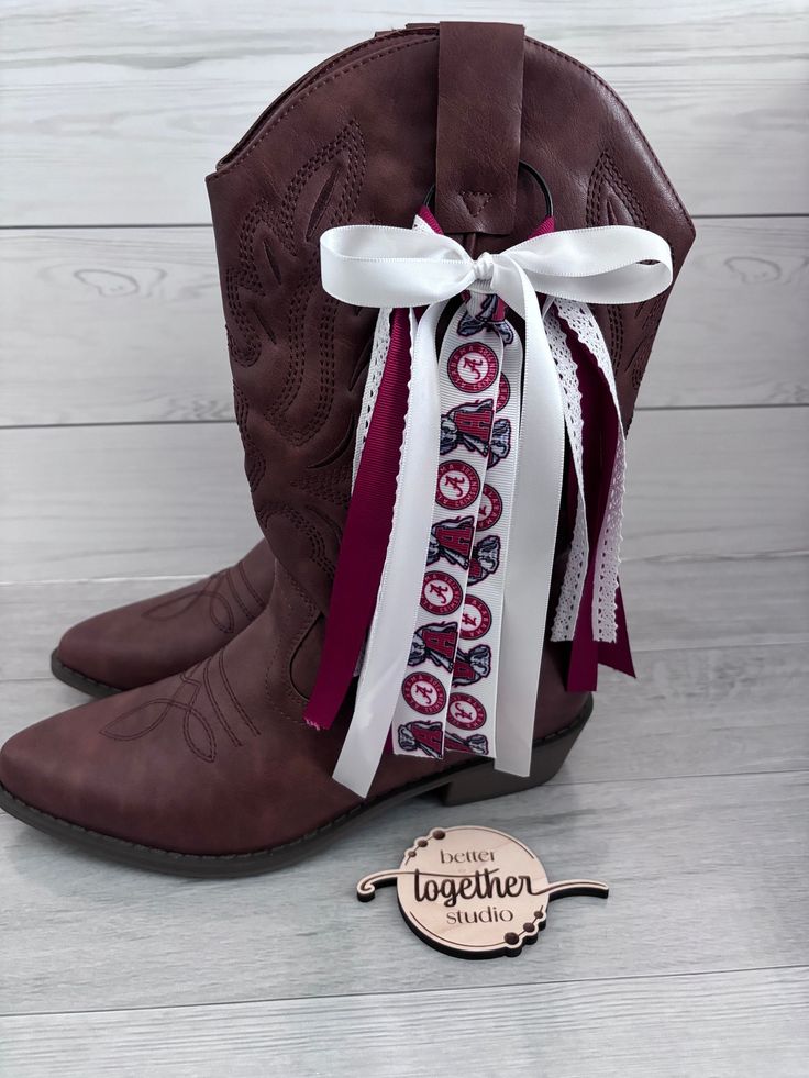 Elevate your game day look with our charming boot bows! Designed to add a touch of flair to your favorite pair of boots, these boot ribbons are perfect for showcasing your school spirit with style. Made from high-quality materials, these bows for boots are durable and easy to attach, allowing you to customize your footwear effortlessly. Whether you're heading to a sports game, a rally, or just strolling around campus, these game day boot bows will surely make you stand out from the crowd. Embrac Ribbons On Cowboy Boots, Boots With Bows, Sports Game, Morgan Wallen, Inspo Board, Cowboy Western, Gameday Outfit, Western Cowboy Boots, School Spirit