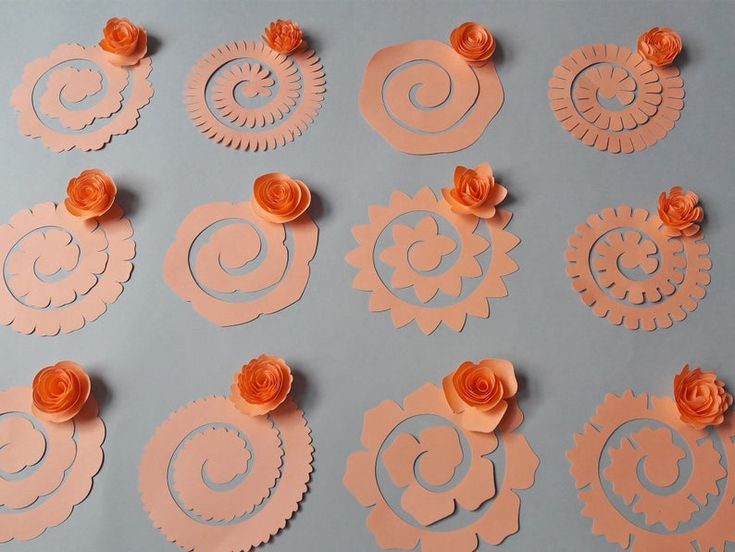 paper flowers are arranged on top of each other and placed in the shape of spirals