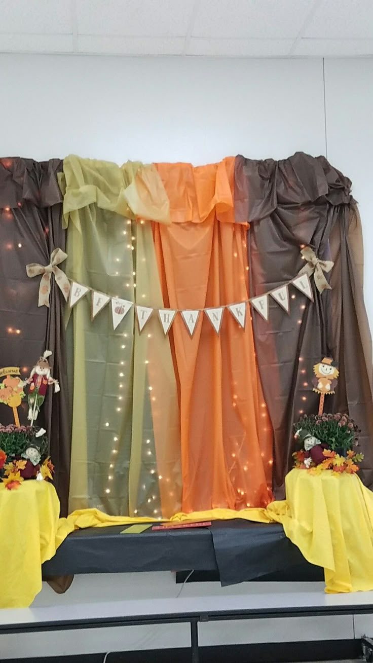 an image of a stage set up with curtains and flowers on the table in front of it