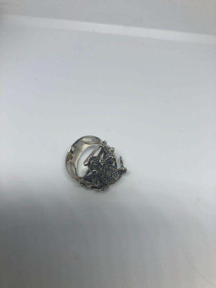 Vintage 1970's 925 Sterling Silver Marcasite Frog Ring Lovely Piece of vintage hand made Marcasite and silver work size 7 Can be re sized, my jeweler charges $10-20 All rings are shipped in a nice gift box. Check out our over a THOUSAND great reviews Engraving is $4 per letter and is not always perfect depending on the piece. It can take a few days if the jeweler is busy. This is payable to Paypal Judithsltd@gmail.com Silver Butterfly Open Ring, Vintage Sterling Silver Snake Ring Gift, Vintage Silver Open Ring Jewelry, Vintage Sterling Silver Snake Ring As A Gift, Vintage Silver Flower Ring For Jewelry Making, Silver Metal Butterfly Open Ring, Silver Open Butterfly Ring, Vintage Nickel-free Silver Skull Ring, Vintage Silver Skull Ring Nickel Free