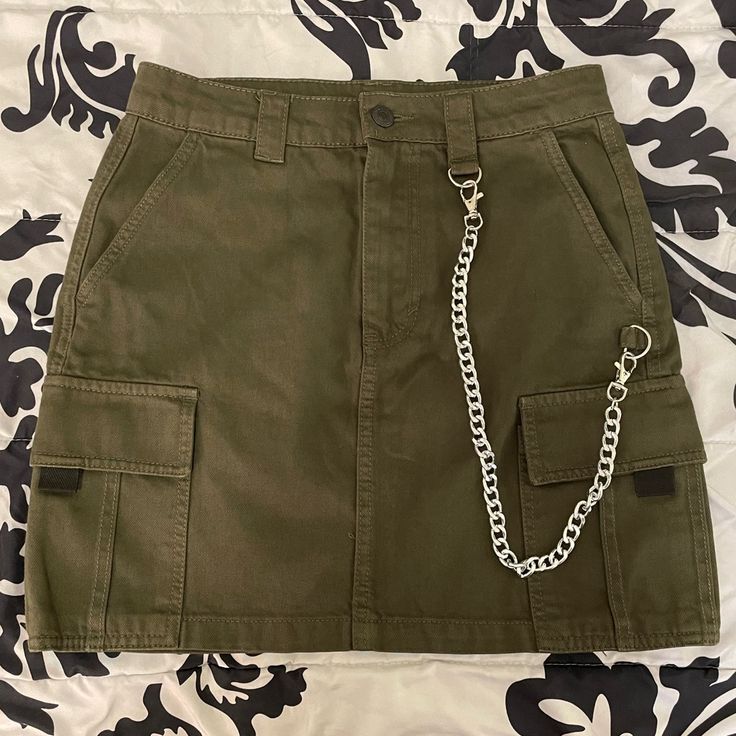 Forever 21 Dark Green Utility/Cargo Mini Skirt. Size Small. Comes With Removable Chain. Functional Pockets. Never Worn. Trendy Khaki Mini Cargo Skirt, Trendy Khaki Mini Skirt, Casual Forever 21 Bottoms With Cargo Pockets, Trendy Mini Skirt With Cargo Pockets, Forever 21 High Waist Skirt With Pockets, High Waist Skirt With Pockets By Forever 21, Forever 21 Mini Skirt With Pockets, Casual Forever 21 Skirt With Pockets, Casual Skirt With Pockets By Forever 21