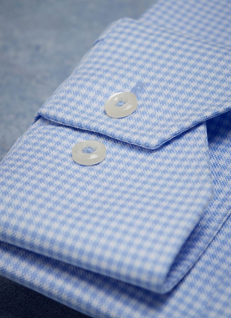 An updated classic gingham, the Alexander in Blue Gingham is crafted is crafted from the smoothest, high density luxury fabric. While the no wrinkle, non-iron fabric has a robust feel, it also has breathability and drape. The Alexander is the trimmest of all our fits, calibrated to accentuate a lean, athletic body type. • Trimmest Fit • 100% Super 80s 2-ply Cotton• Easy Care, Non Iron• Spread Collar• Mitered Barrel Cuff • Imported • Item #LUW9F24 Classic Plaid Fitted Shirt, Classic Fitted Plaid Shirt, Plaid Fitted Classic Shirt, Fitted Light Blue Dress Shirt With Button Closure, Business Gingham Cotton Shirt, Business Cotton Checkered Shirt, Gingham Cotton Dress Shirt For Work, Business Cotton Gingham Shirt, Cotton Gingham Dress Shirt For Work