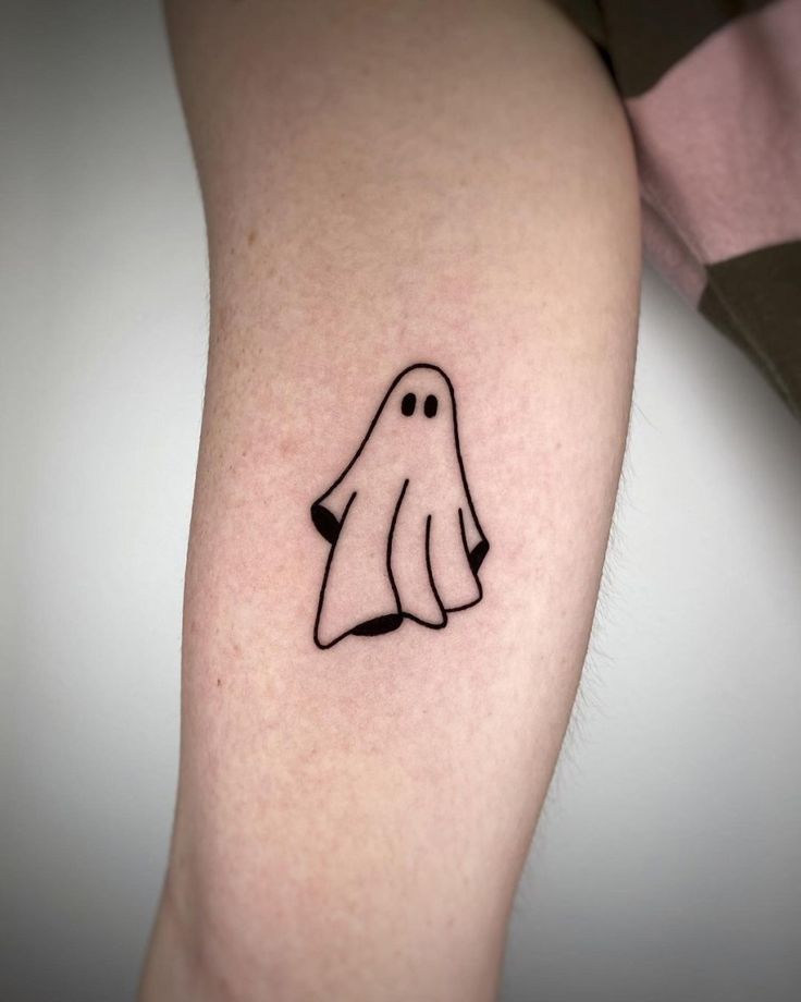 a small ghost tattoo on the arm