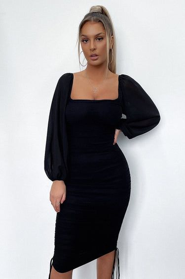 Stand out in the crowd in the Lorde Dress in Black. This babe features an all over ruched fabrication with tie up detail on each side of the dress, off the shoulder, sheer long sleeves and is completed with invisible back zipper. She looks amazing when paired with your go to nude heels and gold jewellery.  FABRICATION: Trendy Square Neck Midi Dress For Party, Black Mini Dress With Elastic Sleeves For Party, Chic Ruched Long Sleeve Dress For Date Night, Chic Midi Dress With Elastic Sleeves For Party, Chic Party Midi Dress With Elastic Sleeves, Sheer Puff Sleeve Dress For Night Out, Ruched Long Sleeve Bodycon Evening Dress, Fall Night Out Dress With Gathered Sleeves, Square Neck Mini Dress With Sheer Sleeves