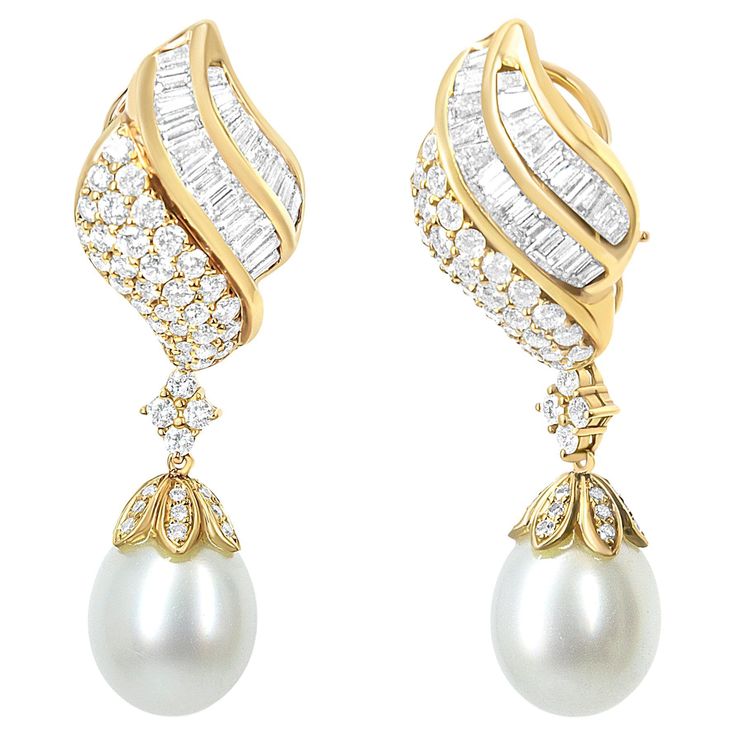 Delicate details indulge this spectacular pair of diamond South Sea pearl drop dangle earrings in splendid form. Crafted in fine 18k yellow gold, each earring features a lustrous 12.5-13.0mm South Sea cultured pearl set below an impressive array of 149 diamonds of 7.0 total cttw, that are of an approximate F-G color and VS1-VS2 clarity. The elegant teardrop-shaped pearl is of a light gray color with medium luster. The pearls are an art-form in a cup setting with scalloped design to form an encha Luxury Chic Yellow Gold Pearl Earrings, Luxury Statement Pear-shaped Pearl Earrings, Luxury Pearl Drop Chandbalis For Celebration, Expensive Diamond, Scalloped Design, Sea Pearl, Pearl Set, Drop Dangle Earrings, Pearl Types