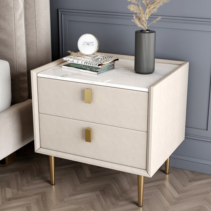 a white nightstand with two drawers and a vase on top