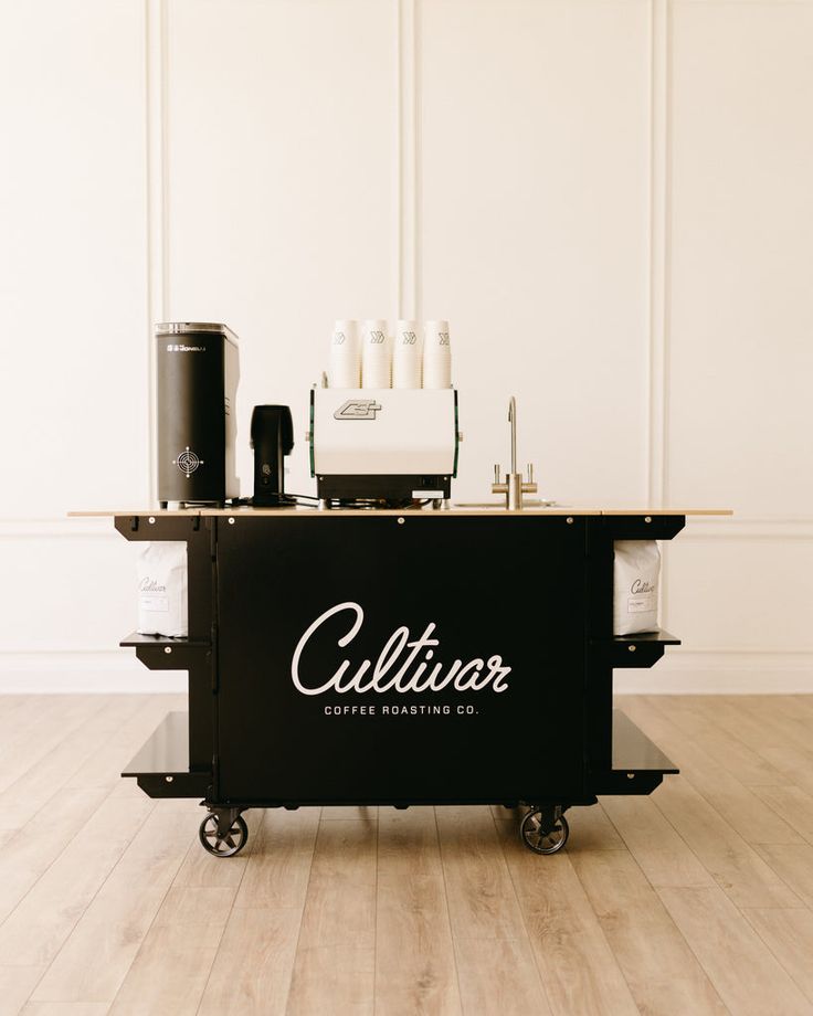 a counter with some bottles on it and a coffee maker in the back ground next to it